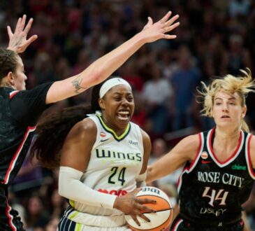 Dallas Wings guard Arike Ogunbowale drives to the basket between Portland Fire defenders Emily Engstler and Karlie Samuelson during the second half at Moda Center on July 22, 2026.