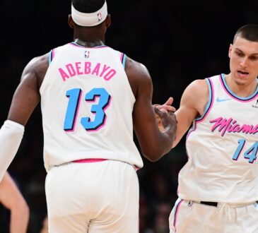 Miami Heat center Bam Adebayo #13 is congratulated by guard Tyler Herro #14 after making a basket against the Boston Celtics at TD Garden.