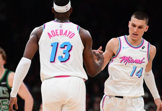 Miami Heat center Bam Adebayo #13 is congratulated by guard Tyler Herro #14 after making a basket against the Boston Celtics at TD Garden.