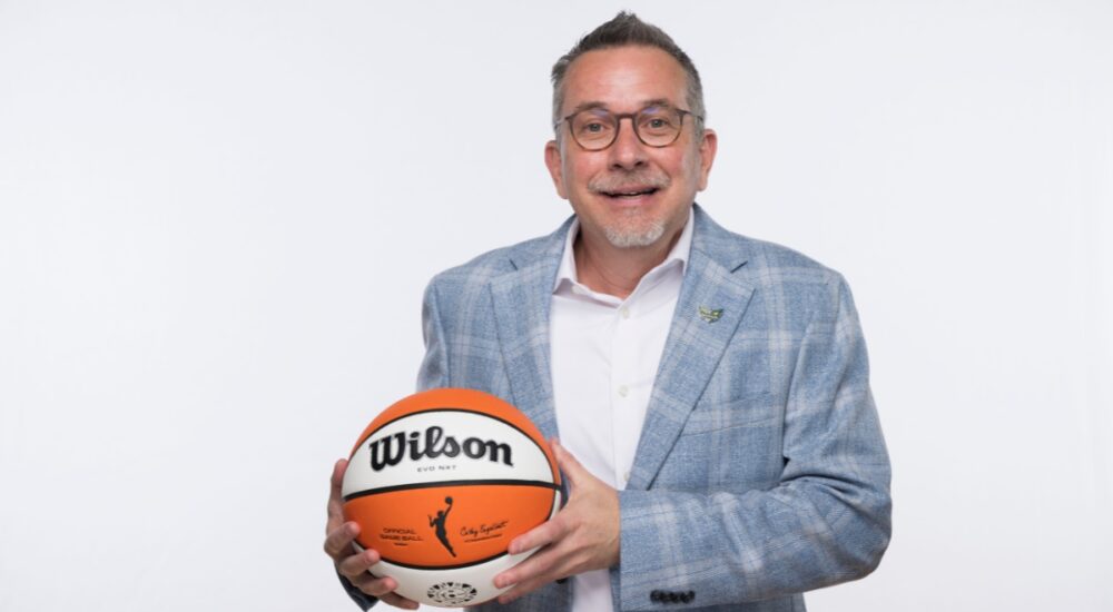 Dallas Wings general manager Curt Miller holds a Wilson WNBA game ball during 2026 Dallas Wings media day at College Park Center.