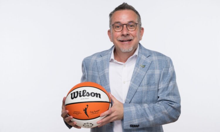 Dallas Wings general manager Curt Miller holds a Wilson WNBA game ball during 2026 Dallas Wings media day at College Park Center.