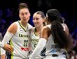 Dallas Wings forward Jessica Shepard, guard Paige Bueckers and guard Arike Ogunbowale huddle during a game against the Chicago Sky at College Park Center.
