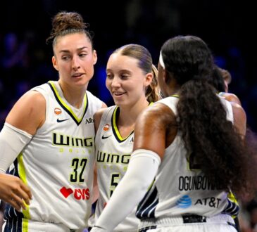 Dallas Wings forward Jessica Shepard, guard Paige Bueckers and guard Arike Ogunbowale huddle during a game against the Chicago Sky at College Park Center.