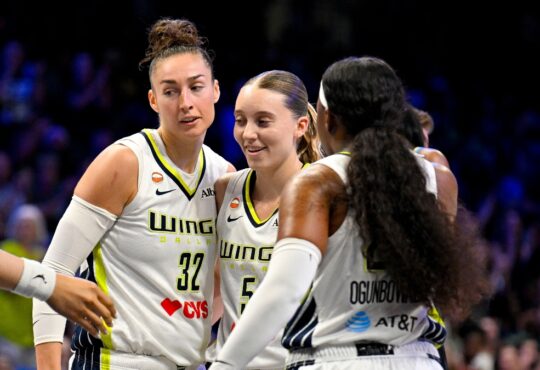 Dallas Wings forward Jessica Shepard, guard Paige Bueckers and guard Arike Ogunbowale huddle during a game against the Chicago Sky at College Park Center.