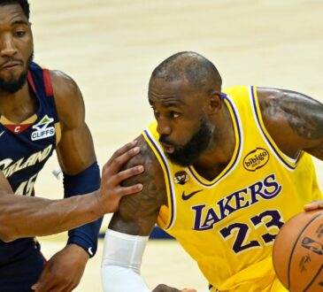 Cleveland Cavaliers guard Donovan Mitchell #45 defends Los Angeles Lakers forward LeBron James #23 during the fourth quarter at Rocket Arena.