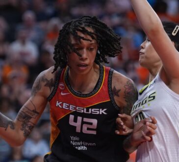 Connecticut Sun center Brittney Griner drives against Dallas Wings center Li Yueru in the second half at PeoplesBank Arena