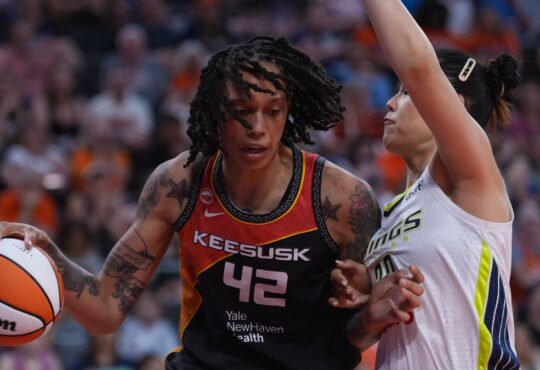 Connecticut Sun center Brittney Griner drives against Dallas Wings center Li Yueru in the second half at PeoplesBank Arena