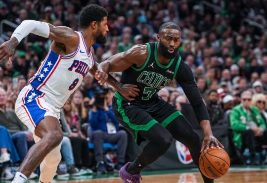 Jaylen Brown drives to the basket while defended by Paul George during a 2026 NBA playoff game between the Celtics and 76ers.