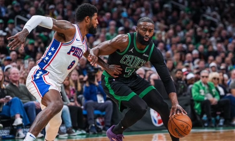 Jaylen Brown drives to the basket while defended by Paul George during a 2026 NBA playoff game between the Celtics and 76ers.