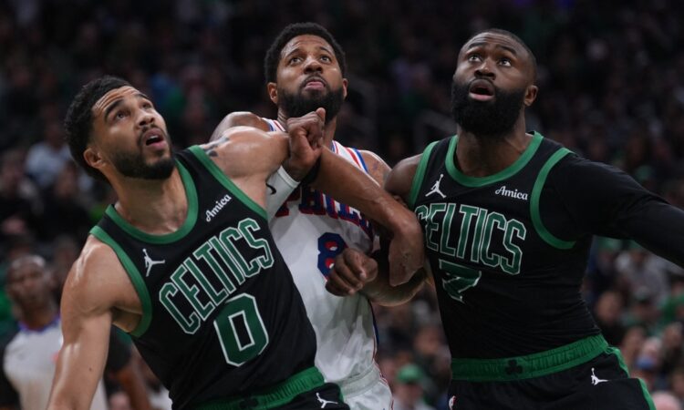 Jayson Tatum #0 and Jaylen Brown #7 of the Boston Celtics look for a rebound against Paul George #8 of the Philadelphia 76ers during Game 5 of the NBA Playoffs at TD Garden.