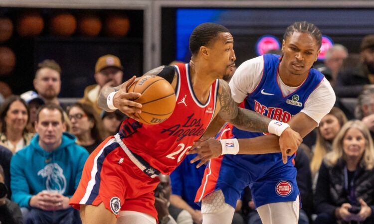 LA Clippers forward John Collins drives against Detroit Pistons guard Ausar Thompson at Little Caesars Arena