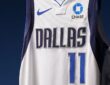 Close-up of a Dallas Mavericks white jersey showing the No. 11 and a new Chase logo patch on the left chest
