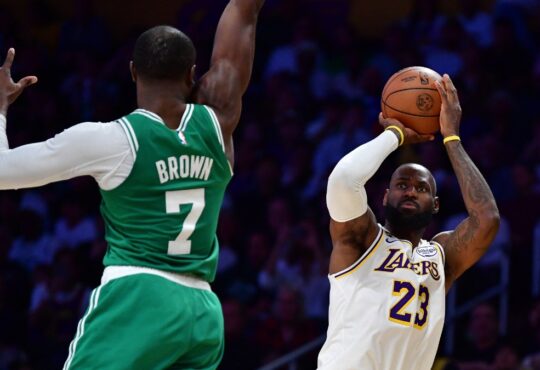 LeBron James of the Lakers shoots a jump shot over Jaylen Brown of the Celtics during a game at Crypto.com Arena