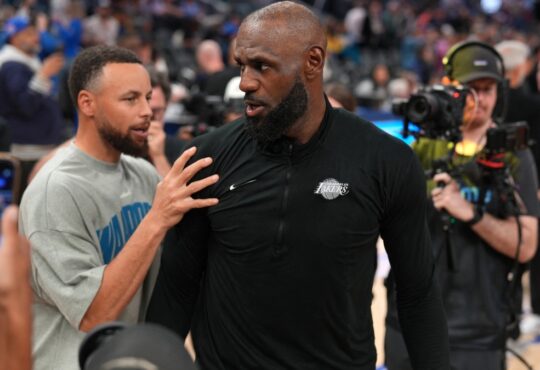 Los Angeles Lakers forward LeBron James #23 meets with Golden State Warriors guard Stephen Curry #30 after a game at Chase Center.