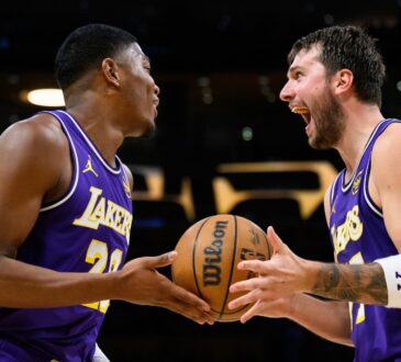 Rui Hachimura #28 and Luka Doncic #77 of the Los Angeles Lakers react after a defensive play against the Brooklyn Nets at Crypto.com Arena.