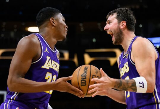 Rui Hachimura #28 and Luka Doncic #77 of the Los Angeles Lakers react after a defensive play against the Brooklyn Nets at Crypto.com Arena.