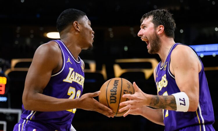Rui Hachimura #28 and Luka Doncic #77 of the Los Angeles Lakers react after a defensive play against the Brooklyn Nets at Crypto.com Arena.