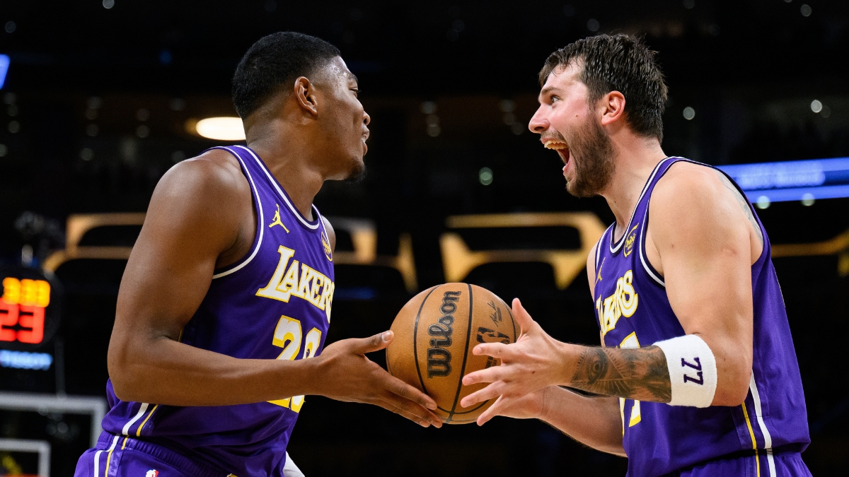 Rui Hachimura #28 and Luka Doncic #77 of the Los Angeles Lakers react after a defensive play against the Brooklyn Nets at Crypto.com Arena.