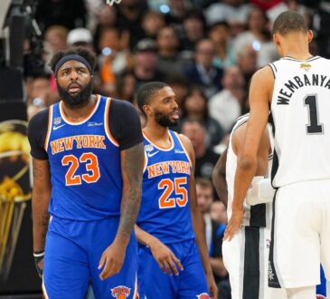 Knicks center Mitchell Robinson and guard Mikal Bridges look on next to Spurs center Victor Wembanyama during the 2026 NBA Finals.