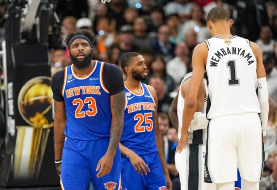 Knicks center Mitchell Robinson and guard Mikal Bridges look on next to Spurs center Victor Wembanyama during the 2026 NBA Finals.