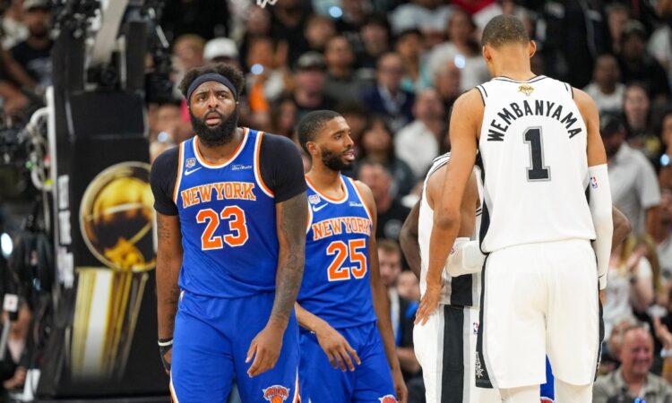 Knicks center Mitchell Robinson and guard Mikal Bridges look on next to Spurs center Victor Wembanyama during the 2026 NBA Finals.