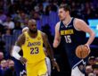 Denver Nuggets center Nikola Jokic controls the ball as Los Angeles Lakers forward LeBron James guards in the fourth quarter at Ball Arena.