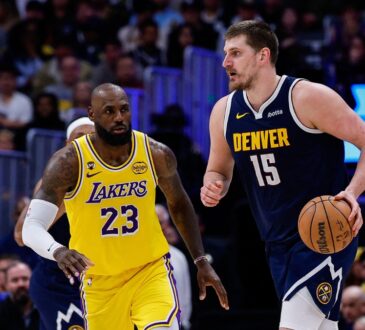 Denver Nuggets center Nikola Jokic controls the ball as Los Angeles Lakers forward LeBron James guards in the fourth quarter at Ball Arena.