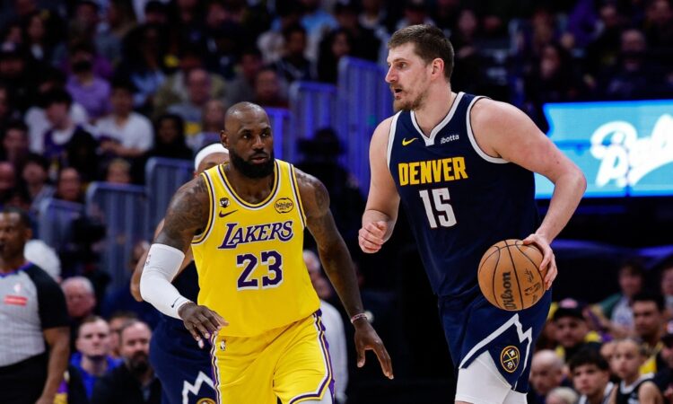 Denver Nuggets center Nikola Jokic controls the ball as Los Angeles Lakers forward LeBron James guards in the fourth quarter at Ball Arena.