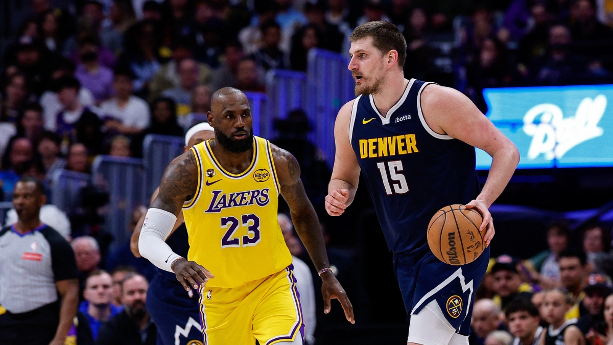 Denver Nuggets center Nikola Jokic controls the ball as Los Angeles Lakers forward LeBron James guards in the fourth quarter at Ball Arena.