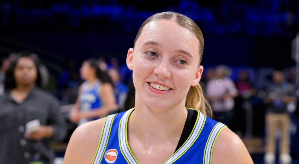 Dallas Wings guard Paige Bueckers smiles on the court at College Park Center after a game against the Las Vegas Aces.