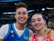 Jessica Shepard, in a blue Team Spoon jersey, and Paige Bueckers, in an orange Team Coop jersey, stand together and smile on the court after the 2026 WNBA All-Star Game.
