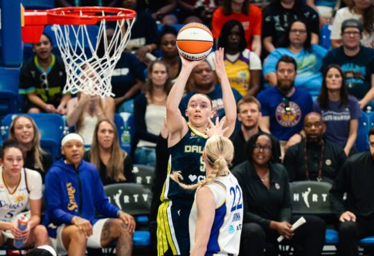 Dallas Wings guard Paige Bueckers (5) elevates for a jump shot over Los Angeles Sparks forward Cameron Brink (22) during Dallas' win over the Sparks on July 19, 2026.