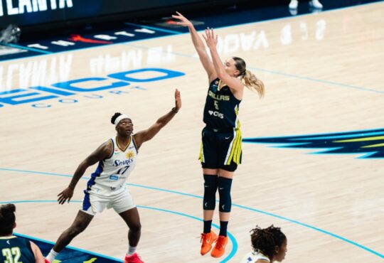Dallas Wings guard Paige Bueckers #5 shoots over a Los Angeles Sparks defender during a WNBA game at College Park Center in Arlington, Texas.
