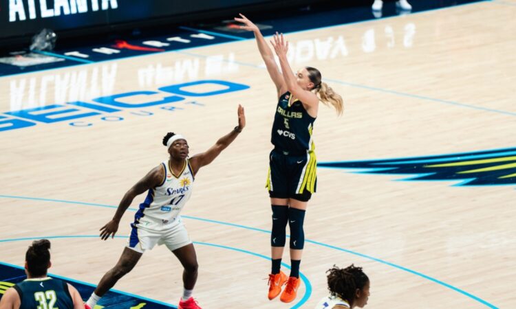 Dallas Wings guard Paige Bueckers #5 shoots over a Los Angeles Sparks defender during a WNBA game at College Park Center in Arlington, Texas.