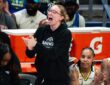 Dallas Wings guard Paige Bueckers claps and cheers from the sideline as guards Sug Sutton and Aziaha James applaud from the bench during a game against the New York Liberty at College Park Center.