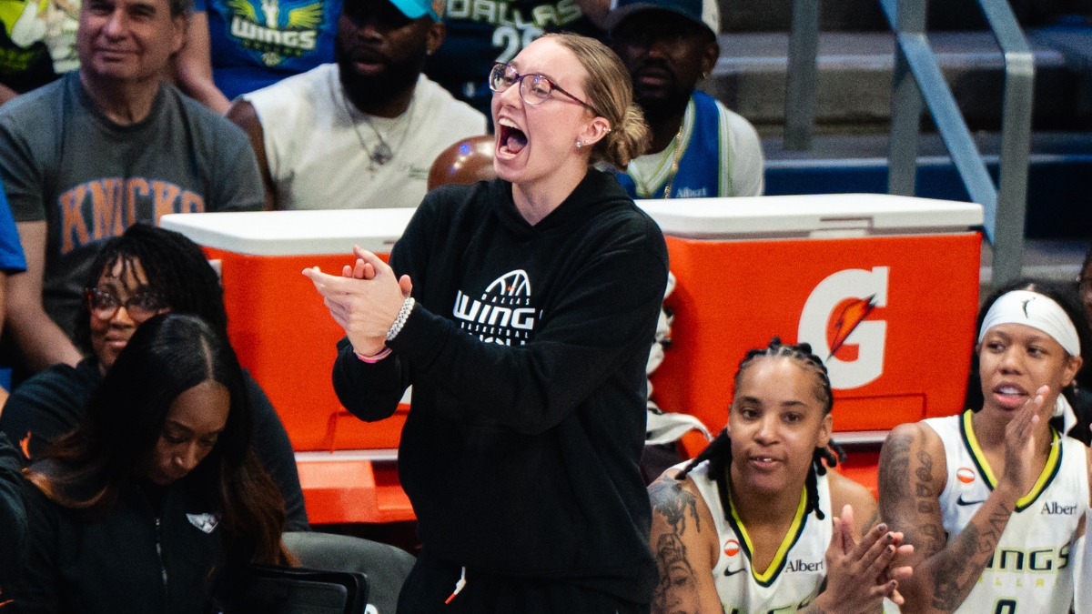 Dallas Wings guard Paige Bueckers claps and cheers from the sideline as guards Sug Sutton and Aziaha James applaud from the bench during a game against the New York Liberty at College Park Center.