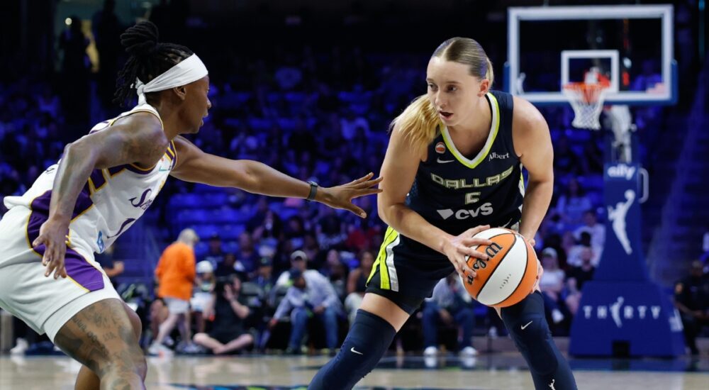 Dallas Wings guard Paige Bueckers controls the ball as Los Angeles Sparks guard Erica Wheeler defends during a game at College Park Center.