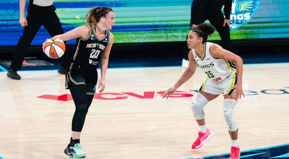 New York Liberty guard Sabrina Ionescu dribbles the ball as Dallas Wings guard Azzi Fudd defends during their game at College Park Center.