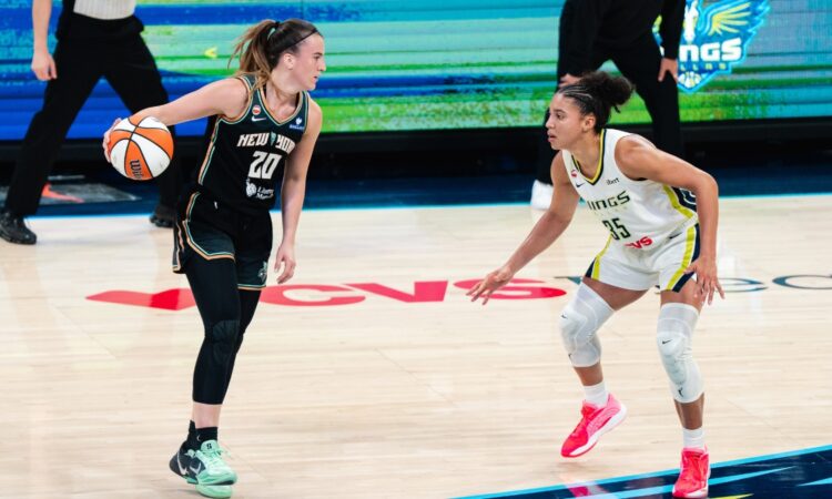 New York Liberty guard Sabrina Ionescu dribbles the ball as Dallas Wings guard Azzi Fudd defends during their game at College Park Center.