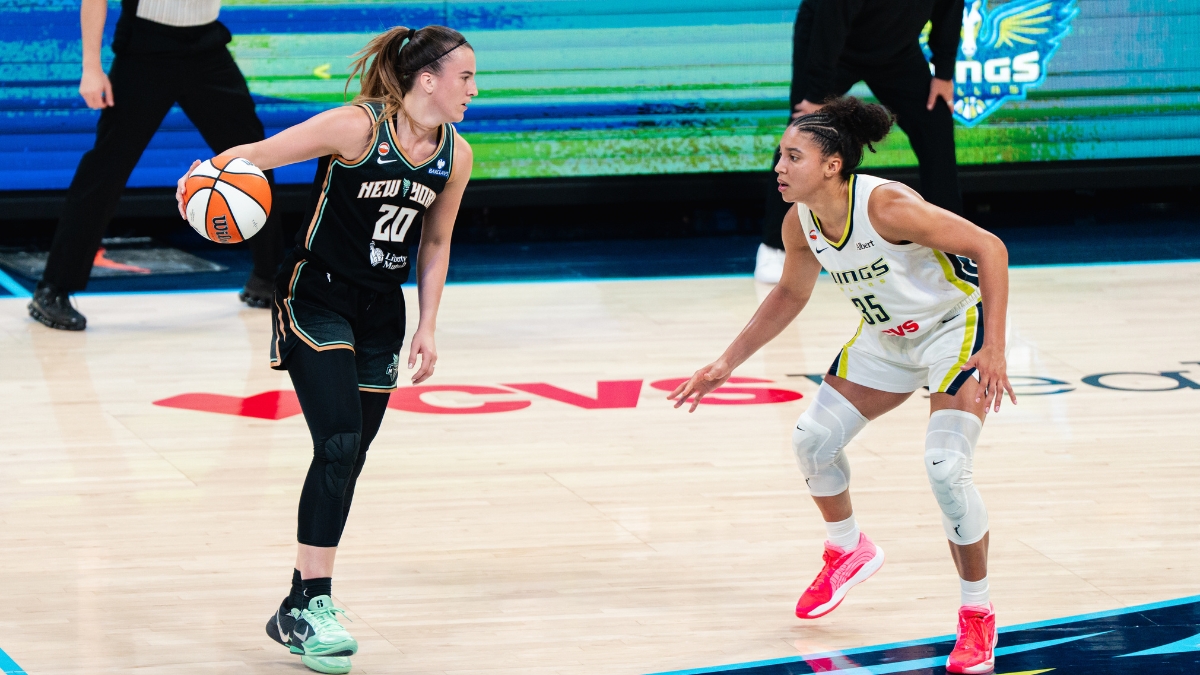 New York Liberty guard Sabrina Ionescu dribbles the ball as Dallas Wings guard Azzi Fudd defends during their game at College Park Center.