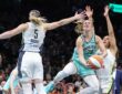 New York Liberty guard Sabrina Ionescu drives to the basket between Dallas Wings defenders Paige Bueckers and Azzi Fudd in the fourth quarter at Barclays Center