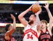 Toronto Raptors forward Sandro Mamukelashvili looks to pass against Chicago Bulls defenders at United Center