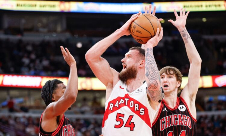 Toronto Raptors forward Sandro Mamukelashvili looks to pass against Chicago Bulls defenders at United Center