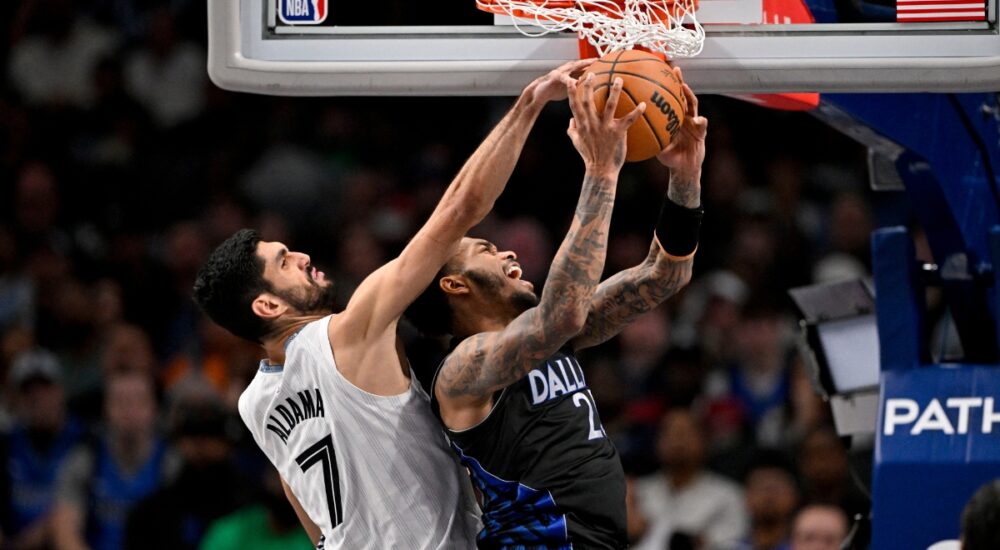 Santi Aldama of the Memphis Grizzlies blocks a shot by P.J. Washington of the Dallas Mavericks