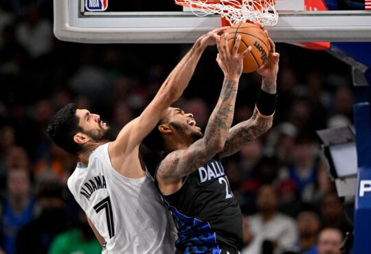 Santi Aldama of the Memphis Grizzlies blocks a shot by P.J. Washington of the Dallas Mavericks