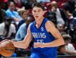Sergio De Larrea dribbles the ball in a Dallas Mavericks Summer League jersey during a game against the Grizzlies