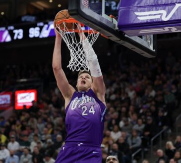 Utah Jazz center Walker Kessler dunks over Los Angeles Lakers forward LeBron James at Delta Center