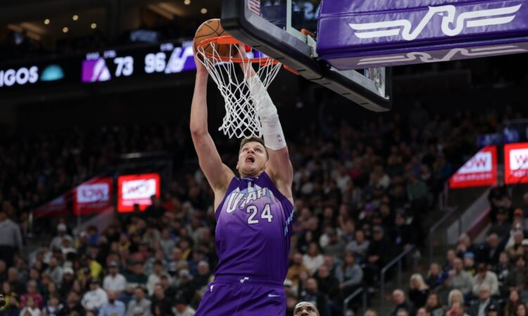 Utah Jazz center Walker Kessler dunks over Los Angeles Lakers forward LeBron James at Delta Center